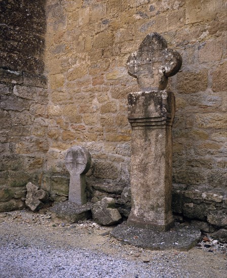 FRANCE, Languedoc-Roussillon, Aude, Montmaur.  Disc shaped crosses outside the Eglise St Baudile thought to be associated with the Cathars.