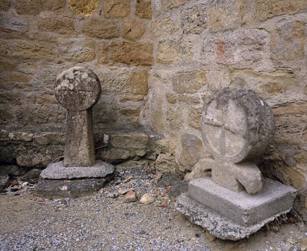 FRANCE, Languedoc-Roussillon, Aude, Montmaur.  Disc shaped crosses outside the Eglise St Baudile thought to be associated with the Cathars.