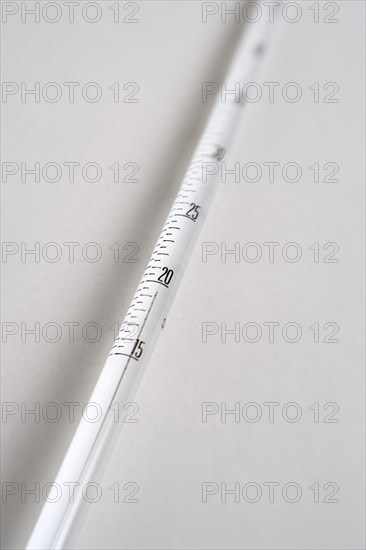 SCIENCE, Medical, Measurement, Detail of white mercury thermometer showing temperature scale and rising mercury level