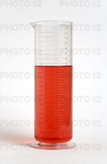 SCIENCE, Medical, Measurement, Plastic measuring beaker containing light red liquid and showing measurements in both millimeters and fluid ounces