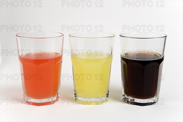 DRINK, Soft Drinks, Sugar, "Soda glasses containing light red, yellow and dark coloured cola soft drinks"
