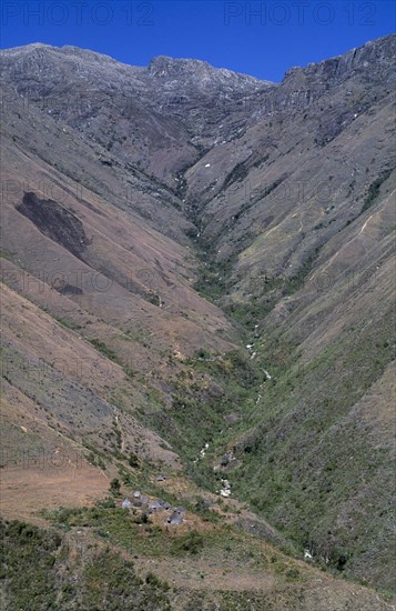 COLOMBIA, Sierra Nevada , Kogi Indigenous Tribe, View  to Surlivaka Religious Centre and valley stretching up to high Sierra. A very sacred community of Kogi mamas priests live in the cluster of old cansa maria temples seen in the valley