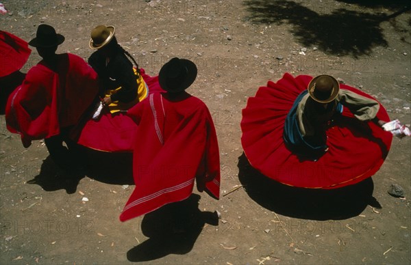 20088972 PERU Puno Lake Titicaca Aymara Andean Indian dancers wearing red skirts and ponchos during marriage festivities