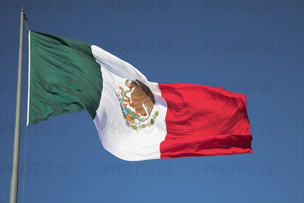 MEXICO, Mexico City, "Mexican flag on Palacio Nacional, Presidential Palace, Zocalo, Plaza de la Constitucion"