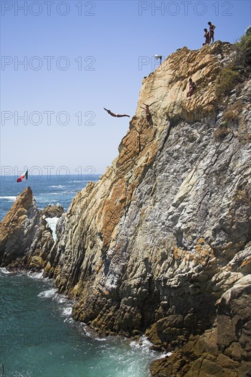 MEXICO, Guerrero State, Acapulco, "Cliff diver, a clavadista, diving off the cliffs at La Quebrada"