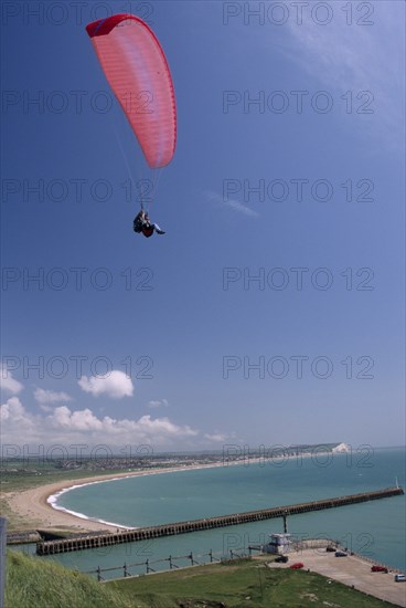 SPORT, Air, Paragliding, "Tandem paraglider above Fort Newhaven with the Mole, Lighthouse, Seaford bay and Seaford in the background."