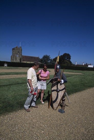 ENGLAND, East Sussex, Battle, Battle Abbey. Saxon foot soldier talking to visitors in the grounds near to the spot where King Harold fell in the battle on Saturday 14th October 1066