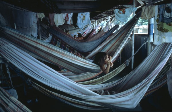 BRAZIL, Amazon, Transport, Child lying in hammock accommodation on Amazon river boat between Belem and Manaus