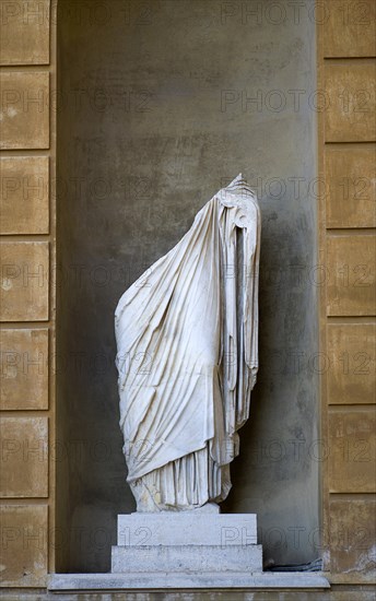 ITALY, Lazio, Rome, Vatican City Museum Belvedere Palace Marble statue in a niche of the lower half of a man cut in two wearing a toga