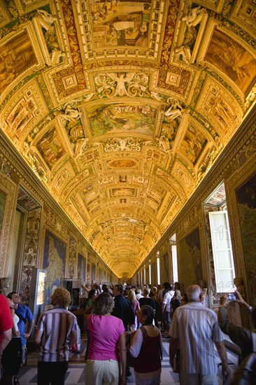 ITALY, Lazio, Rome, Vatican City Museum Tourists in the Gallery of Maps showing the illuminated ceiling and the walls lined with 16th Century cartography