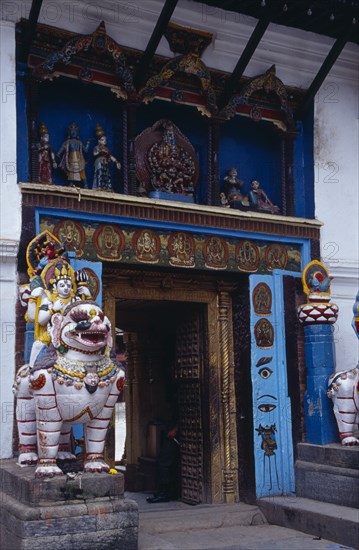 NEPAL, Kathmandu, Dubar Square. Royal Palace or Hanuman Dhoka. Statue of Shakti riding a lion next to private entrance to palace.