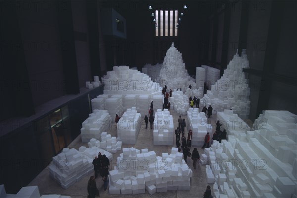 ENGLAND, London, "Tate Modern. Turbine Hall. Exhibition by Rachel Whiteread called Embankment. 14,000 transluscent white polyethylene boxes stacked in various ways. View looking down over visitors walking around exhibit."