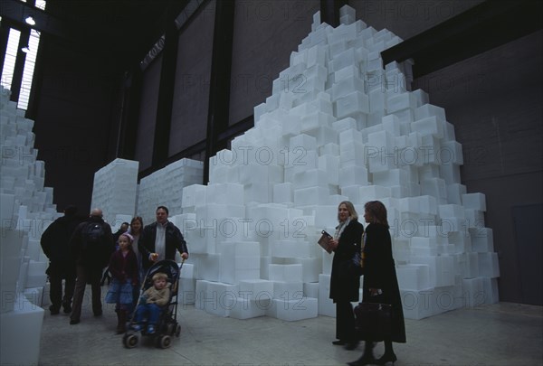 ENGLAND, London, "Tate Modern. Turbine Hall. Exhibition by Rachel Whiteread called Embankment. 14,000 transluscent white polyethylene boxes stacked in various ways. Visitors walking around."