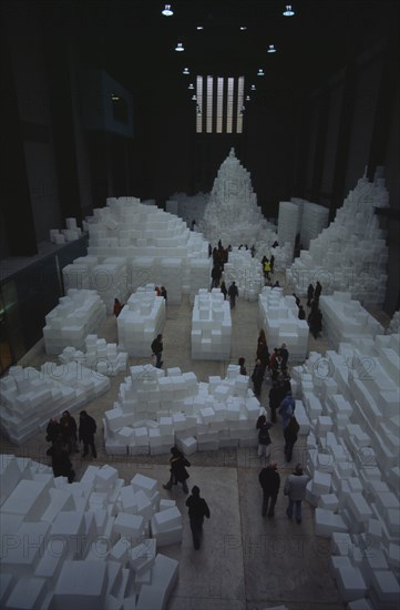 ENGLAND, London, "Tate Modern. Turbine Hall. Exhibition by Rachel Whiteread called Embankment. 14,000 transluscent white polyethylene boxes stacked in various ways. View looking down over visitors walking around exhibit."