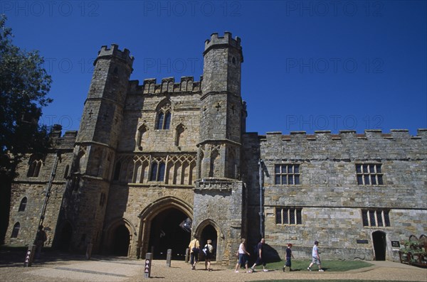 ENGLAND, East Sussex, Battle, Battle Abbey. Partially ruined abbey complex. The Gatehouse seen from interior courtyard with visitors walking through