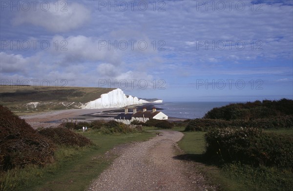 ENGLAND, East Sussex, Seven Sisters, The Seven Sisters white chalk cliffs viewed from a path at Seaford Head