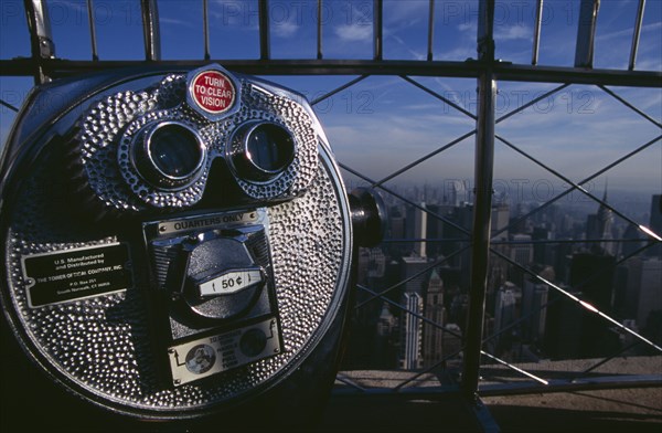 USA, New York, New York City, View north over city  from top of the Empire State Building with coin operated tourist binocular telescope in foreground.