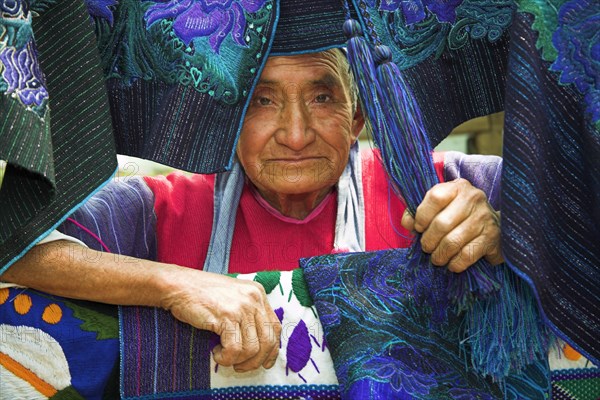 MEXICO, Chiapas, San Lorenzo Zinacantan, "Lady with colourful table mats, near San Cristobal de las Casas"