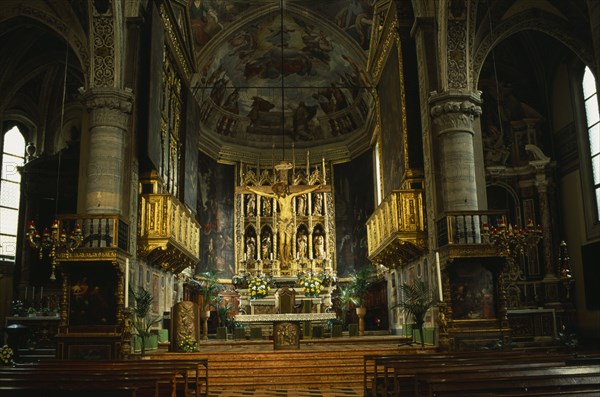 ITALY, Lombardy, Lake Garda, "Salo.  Interior of the Duomo with ornate golden altarpiece, crucifix and painted walls and vaulted ceiling."