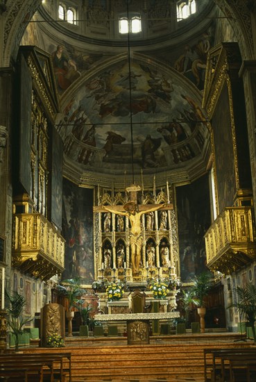 ITALY, Lombardy, Lake Garda, "Salo.  Interior of the Duomo with ornate golden altarpiece, crucifix and painted walls and vaulted ceiling."