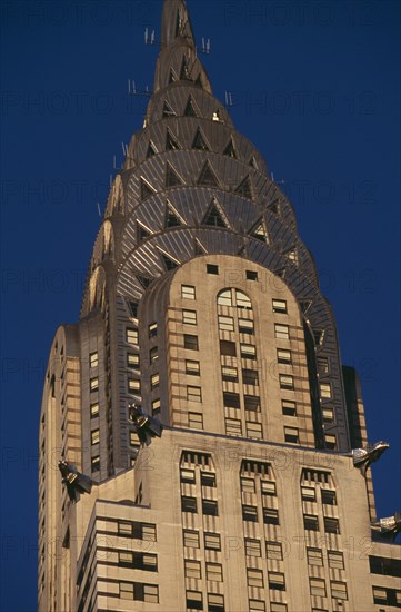 USA, New York, New York City, Part view of the Chrysler Building from Lexington Avenue.  Steel framed Art Deco skyscraper built 1928-1930.  Designed by architect William Van Alen.