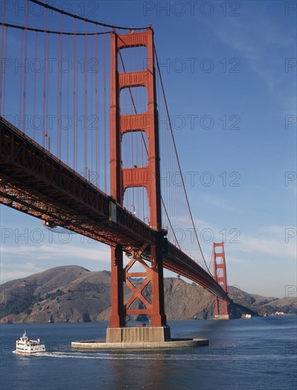 USA, California, San Francisco, The Golden Gate Bridge with a ferry traveling past on the water below