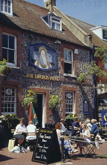 ENGLAND, East Sussex, Brighton, The Druids Head Pub exterior with people sat outside at tables