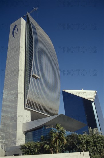 UAE, Dubai, The Creek. National Bank of Dubai and Chamber of Commerce buildings against a blue sky