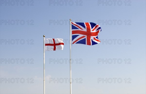 WEATHER, Climate, Wind, British Union Jack and St George Cross flags fyling against a blue sky