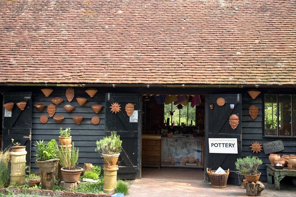 ENGLAND, West Sussex, Amberley, Amberley Working Museum. Pottery building with examples of clay work on display