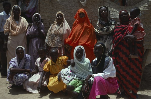 SUDAN, South Tokar, People, Beni Amer nomadic Arab extended family.  Note facial scarification of women.