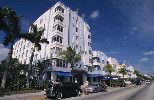 USA, Florida, Miami , South Beach. Ocean Drive. Art Deco Park Central Hotel  exterior lined with palm trees and cars parked outside
