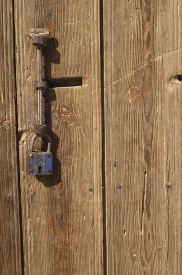 TURKEY, Cappadocia, Cavusin, Detail of wooden door with metal handle and padlock.