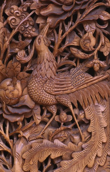 CHINA, Yunnan Province, Dali, "Detail of traditional door carving depicting bird, leaves and flowers."