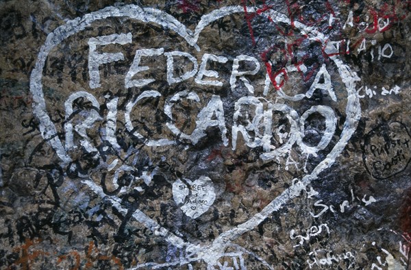 ITALY, Veneto, Verona, "Detail of lover’s graffiti at Juliet’s house, the Casa di Giulietta, number twenty-seven Via Cappello.  Names enclosed by white outline of a heart."