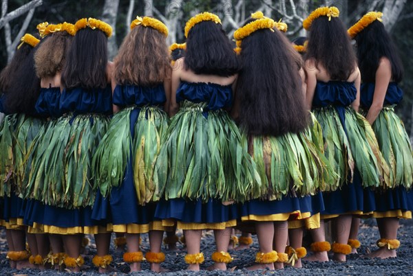 USA, Hawaii, Halemaumau Crater, "Group of dancers stand in circle with bowed heads beside the crater to give thanks to the goddess Pele after winning the annual contest for the ancient hula.  Whilst there is renewed interest in the hula, the majority of dancers are white Caucasian Americans (haoles) or Asian Americans (hapa-haoles) who do not speak the Hawaiian language."