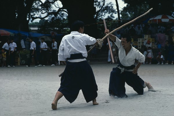 JAPAN, Kyushu, Kaseda, Villagers fighting with sticks replacing swords during the samurai festival of Kaseda shrine.  Masks and protective clothing are not worn.
