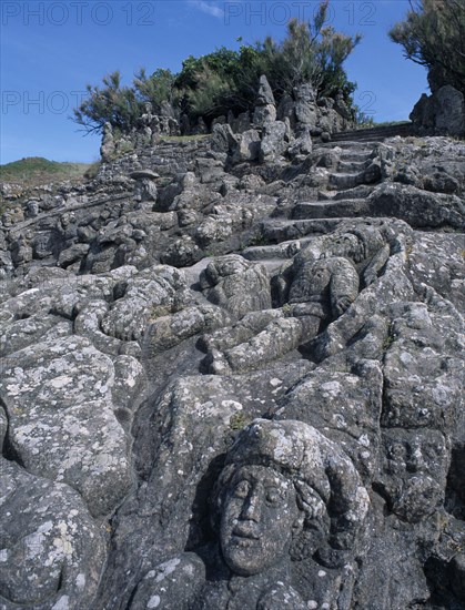 FRANCE, Brittany, St Malo, Rochers Sculptes de Rotheneuf. Sculptures of faces carved into rock