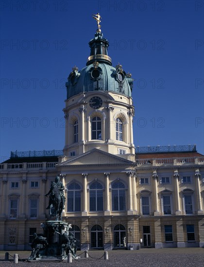 GERMANY, Berlin, Charlottenburg Palace. Exterior section of dome and clock seen from the courtyard with bronze equestrian statues