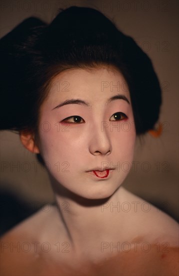 JAPAN, Customs, Geisha, "Head and shoulders portrait of sixteen year old Someiyu, a maiko or apprentice geisha with white powdered face and lips outlined in red. "