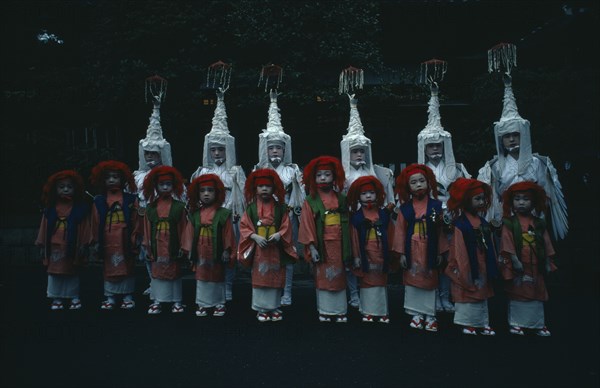 JAPAN, Honshu, Kyoto, Gion Festival.  Children dressed for Shinto dances pose for photographer at the Yasaka Shrine.