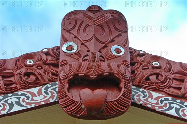 NEW ZEALAND, NORTH ISLAND, ROTORUA, "CENTRAL CARVING OF A MAORI MEETING HOUSE OR WHARENUI WHERE THE TRIBE MET AT TE PUIA MAORI ARTS AND CRAFTS INSTITUTE, ROTORUA."