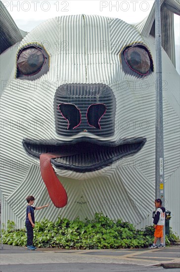 NEW ZEALAND, NORTH ISLAND, WAIKATO, "TIRAU, A CORRUGATED IRON SHEEPDOG WHICH IS THE TOWNS TOURIST INFORMNATION CENTRE OFF MAIN STREET IN TIRAU TOWN, SOUTH WAIKATO, NORTH ISLAND. BUILT IN 1998 AT NIGHT THE DOGS EYES AND NOSE LIGHT UP."