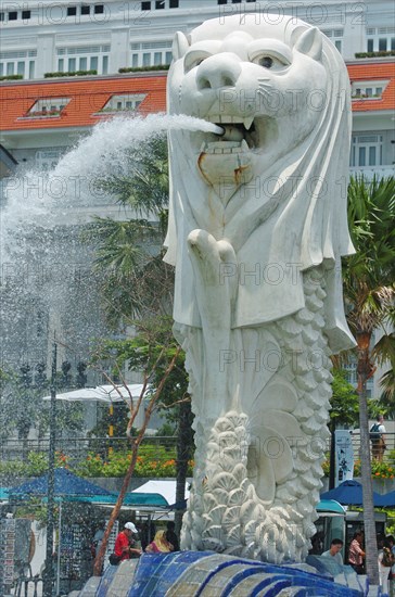 SINGAPORE, MERLION STATUE , "SITUATED INFRONT OF THE FULLERTON HOTEL AND FINACIAL DISTRICT BEHIND. The Merlion is one of the most well-known tourist icons of Singapore. Its landmark statue, once at the Merlion Park, was relocated to the front of the Fullerton Hotel in April 2002.In 2002, the statue was relocated to its current site that fronts Marina Bay with the completion of the Esplanade Bridge in 1997. The statue measures 8.6 metres high and weighs 70 tonnes. The merlion was designed by Fraser Brunner for the Singapore Tourism Board in 1964 and was used as its logo up to 1997. The Merlion continues to be its trademark symbol."