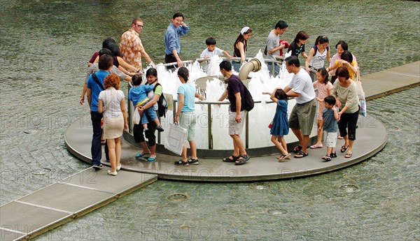 SINGAPORE, Suntec City , "VIEW OF THE BASE OF THE FOUNTAIN OF WEALTH WITHIN THE SUNTEC CITY SHOPPING COMPLEX. The circular ring top of the fountain is visible at ground level. During certain periods of the day, the fountain is turned off and visitors are invited to walk around a mini fountain at the centre of the fountain's base for good luck. "