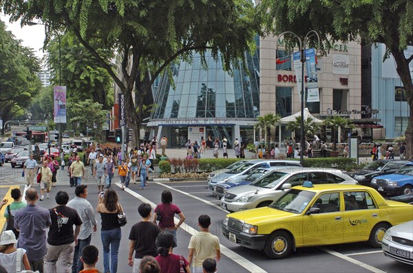 SINGAPORE, Orchard Stree, People crossing busy street.