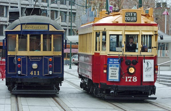 NEW ZEALAND, SOUTH ISLAND, CHRISTCHURCH, "CANTERBURY, CITY TOUR TRAMS AT A TRAM STOP IN CATHEDRAL SQUARE."