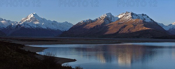 NEW ZEALAND, SOUTH ISLAND, WEST COAST, "MOUNT COOK NATIONAL PARK, VIEW OF NEW ZEALANDS HIGHEST MOUNTAIN MOUNT COOK (LEFT) AND MOUNT JOHNSON (RIGHT) WITH EVENING SUN ON THEIR WEST FACES WITH LAKE PUKAKI BELOW TAKEN FROM ROUTE 80 MOUNT COOK ROAD."