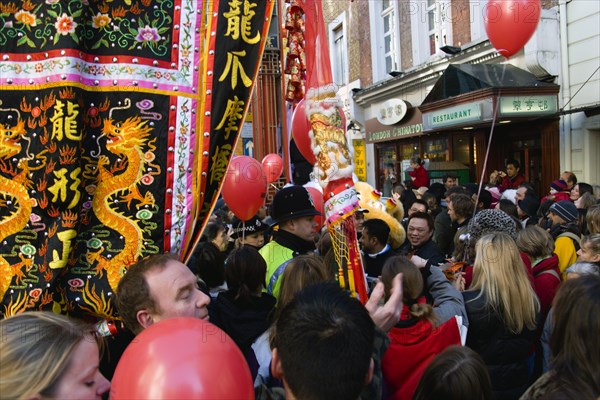 ENGLAND, London, Chinatown, Red and yellow lanterns hanging above Gerrard Place and a banner reading Kung Hei Fat Choi or Happy New Year in Chinese during Chinese New Year celebrations in 2006 for the coming Year of The Dog