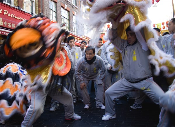 ENGLAND, London, Chinatown, Red and yellow lanterns hanging above crowds of people in Gerrard Place during Chinese New Year celebrations in 2006 for the coming Year of The Dog